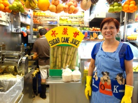 Hawker in Singapore selling fresh fruit juices including sugar cane, star fruit, coconuts, and more | Shopkeeper Stories